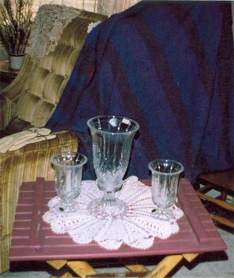 Table with crocheted doilies and glasses